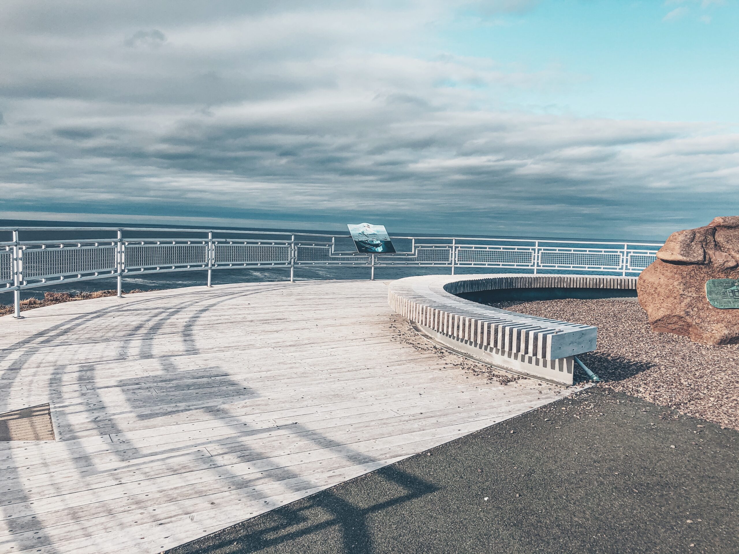A photo of the large round wooden observation deck near the end of the trail, with ocean just beyond it.
