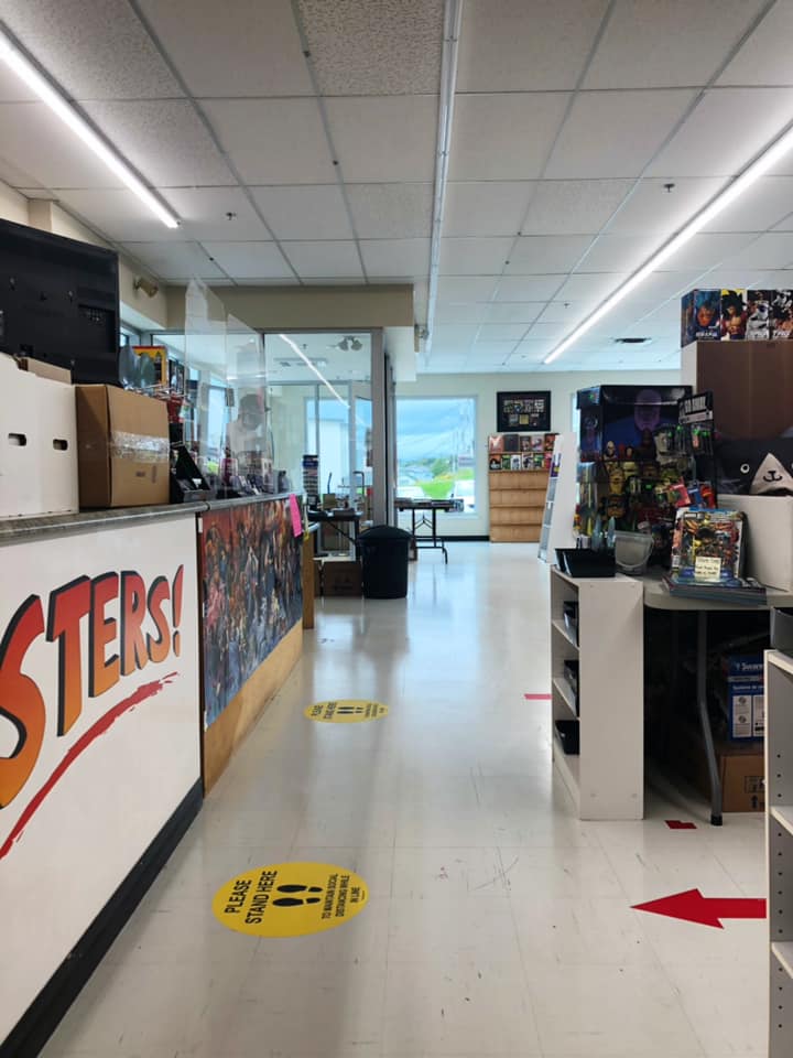 A photo of the front aisle of the store with the checkout counter to the left.