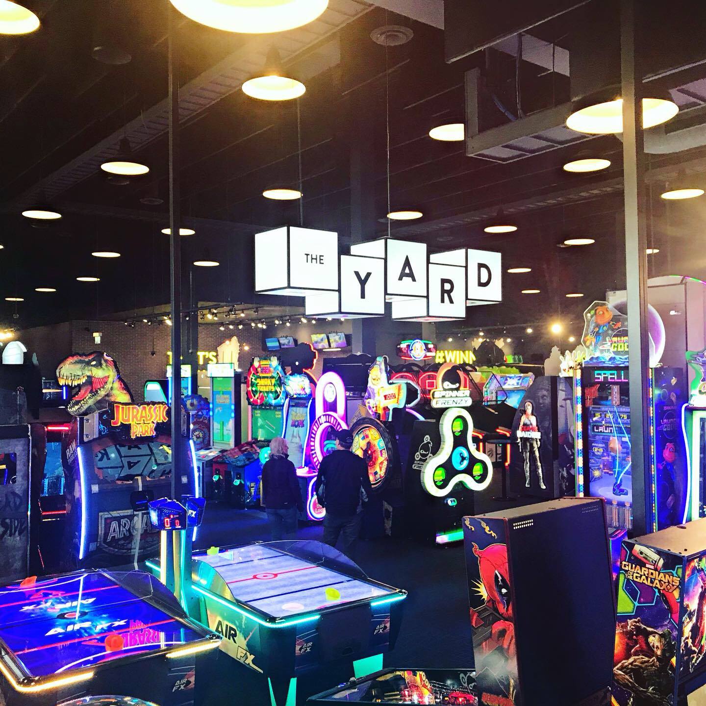 a picture of the arcade area of The Rec Room with a large sign overheard that reads: The Yard.