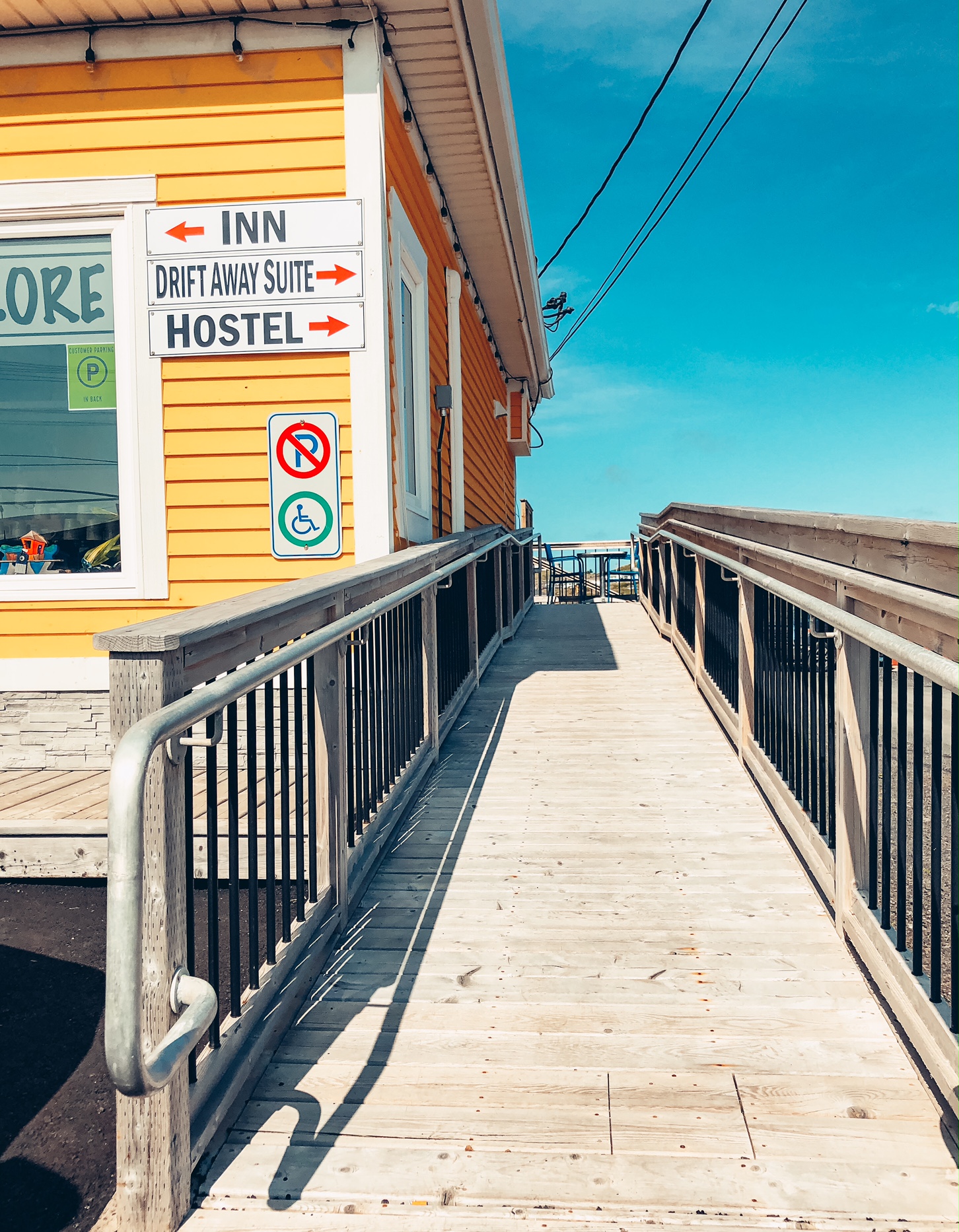 A photo of the wooden ramp running alongside the Artisan Market, which leads to the deck of Drift Away Suite.