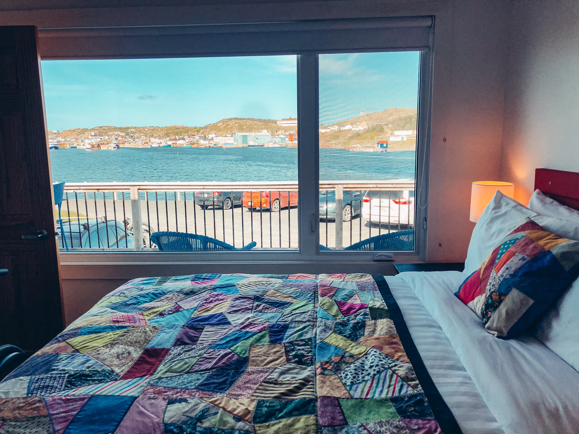 A photo of the view of the harbour from the large window next to the queen sized bed in the main bedroom.
