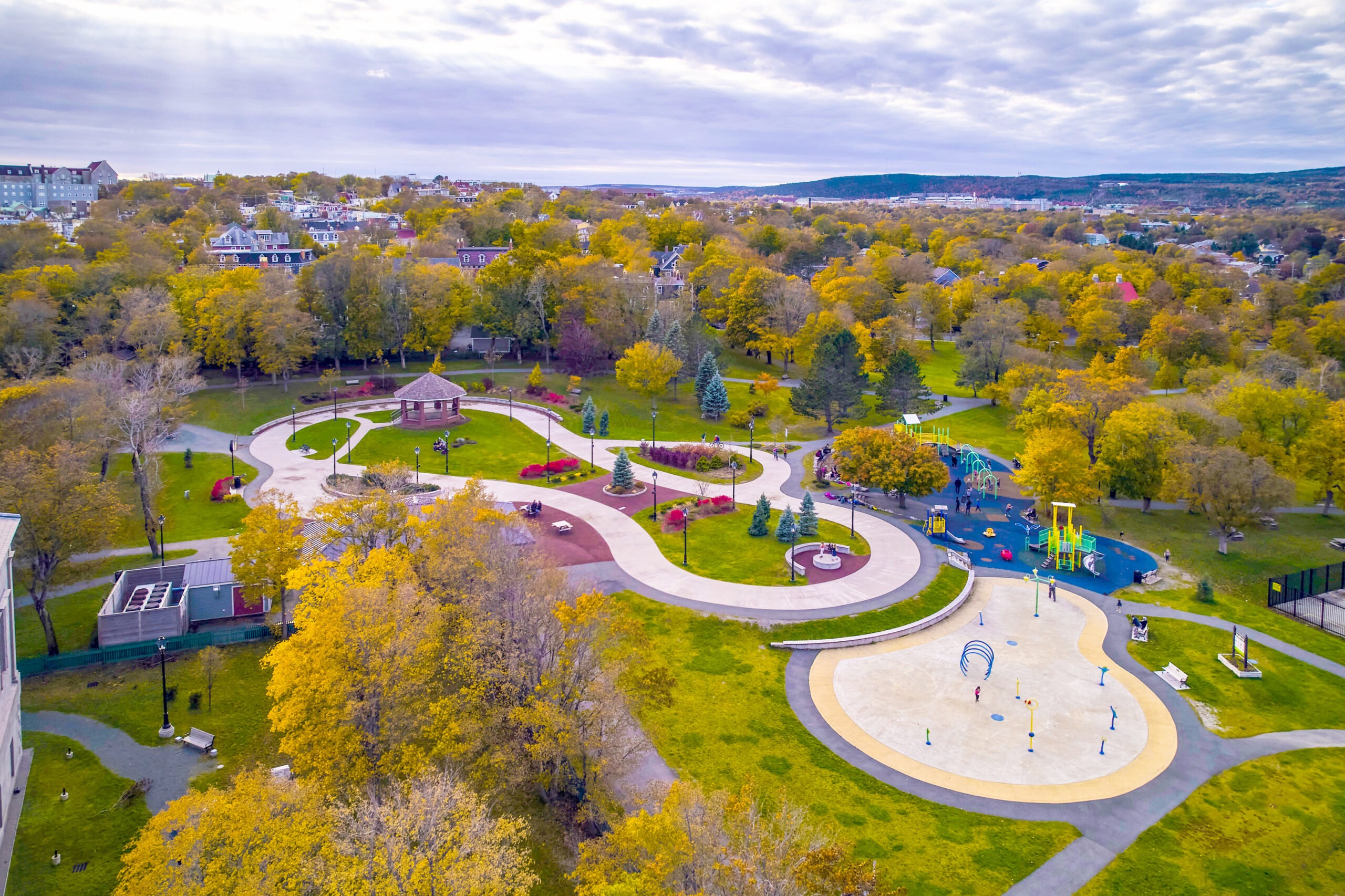 A bird's eye view of Bannerman Park that shows the green space, the skating loop, the playground and splash pad. 