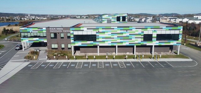 An exterior shot of the H.G.R. Mews building which shows a long row of wheelchair accessible parking spaces next to it.